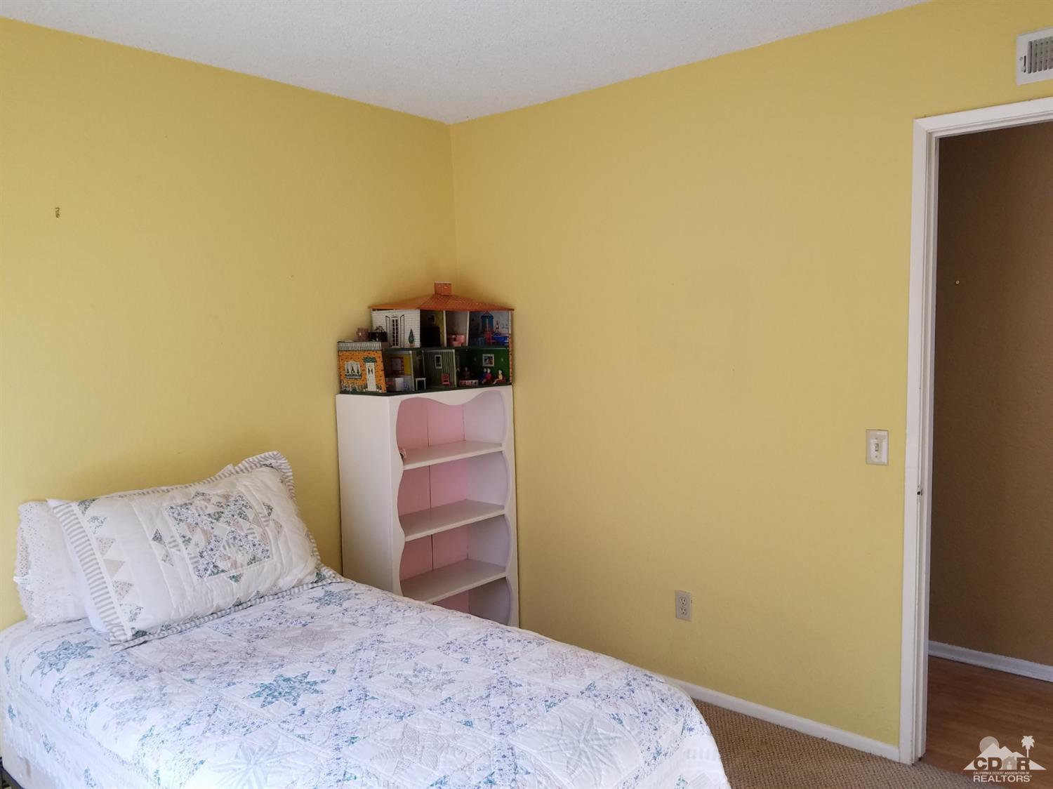 3166 Tomahawk Circle Riverside, CA 92503 - Photo 13 of 29 a bedroom with a bed and a wall painting
