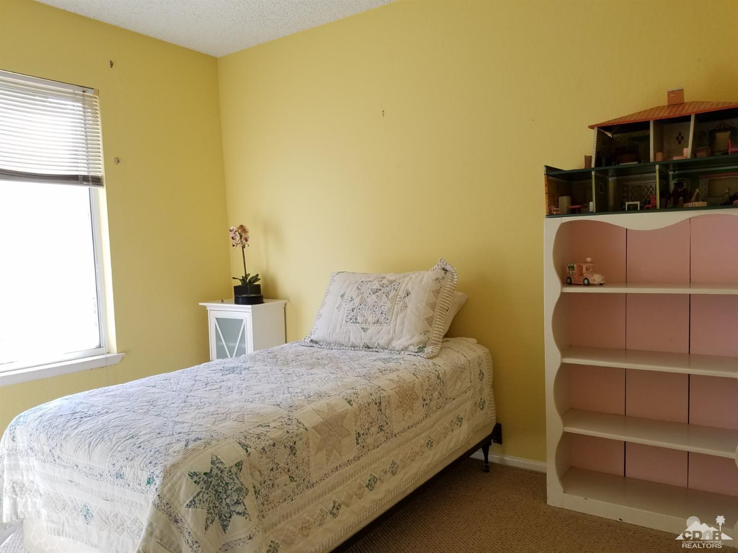 3166 Tomahawk Circle Riverside, CA 92503 - Photo 14 of 29 a bedroom with a bed and a window