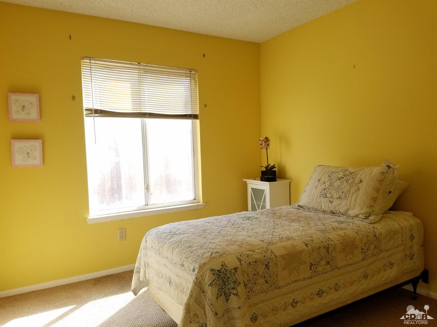 3166 Tomahawk Circle Riverside, CA 92503 - Photo 15 of 29 a bedroom with a bed and a window