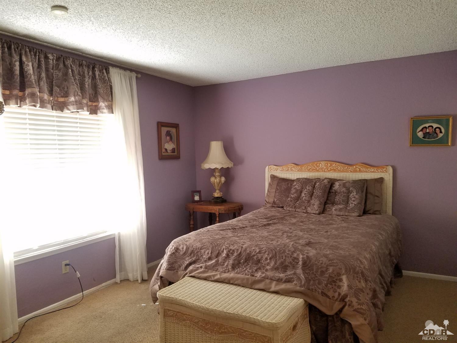 3166 Tomahawk Circle Riverside, CA 92503 - Photo 18 of 29 a bedroom with a bed and a window
