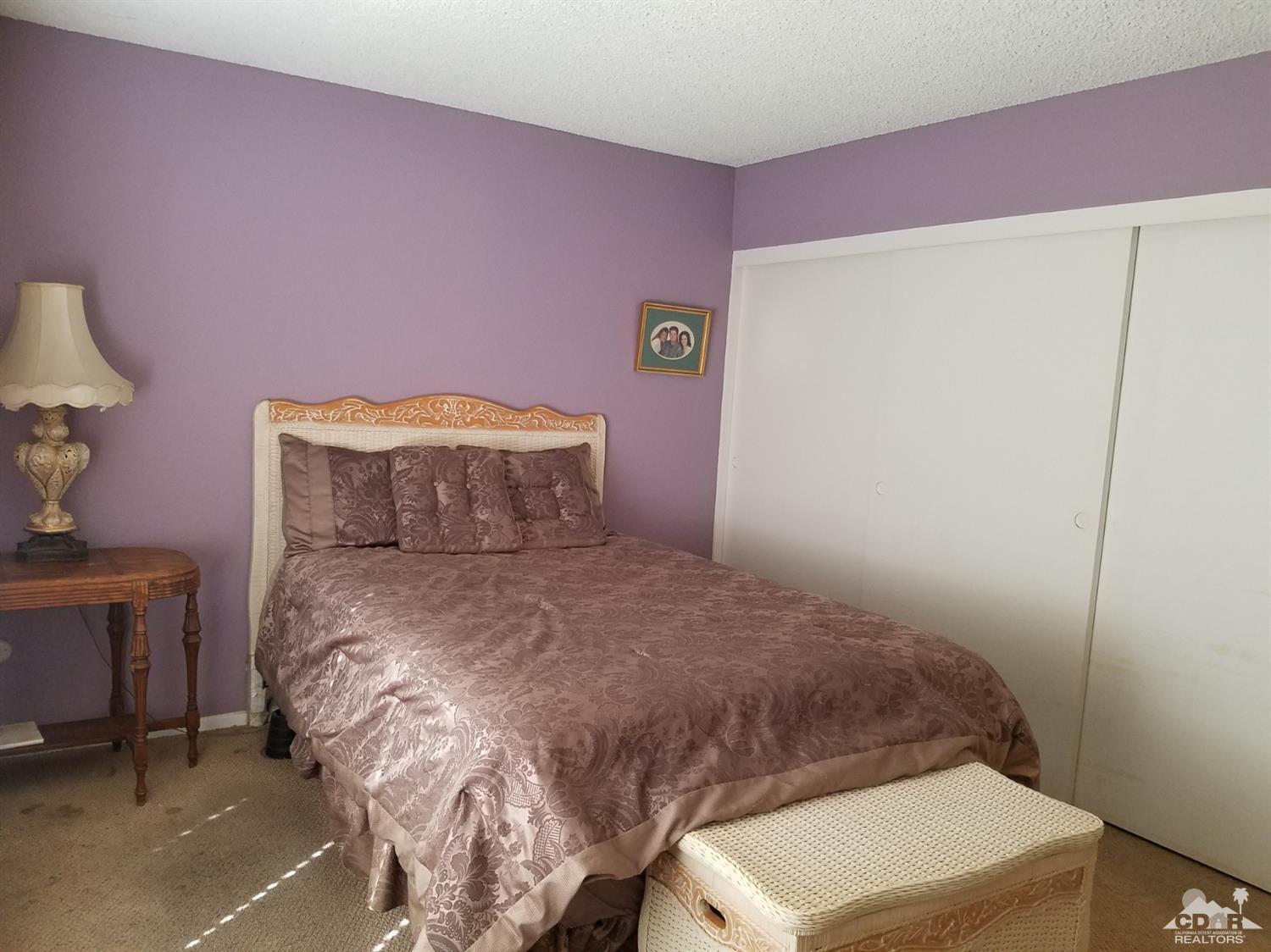 3166 Tomahawk Circle Riverside, CA 92503 - Photo 19 of 29 a bedroom with a bed and a mirror