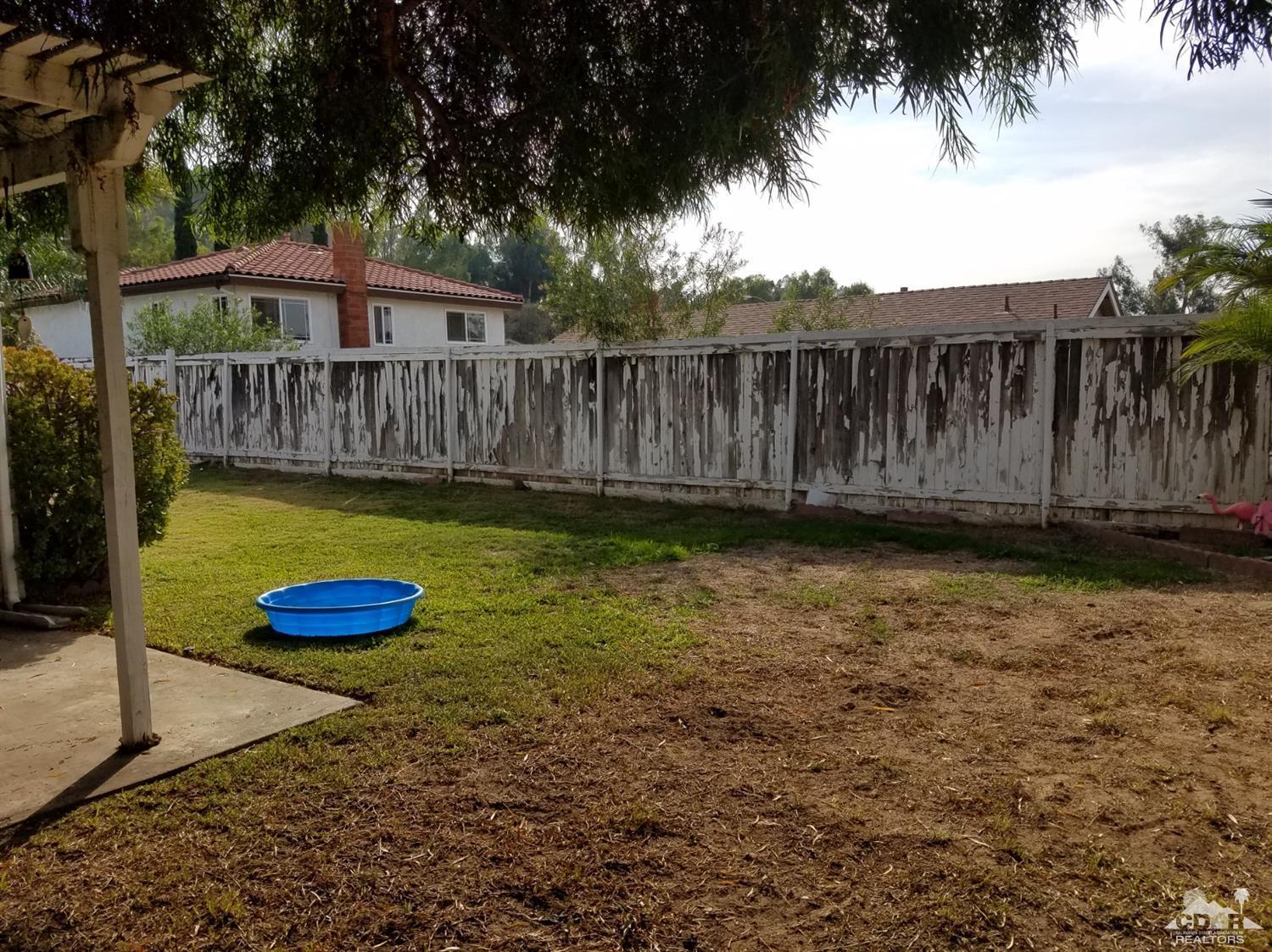 3166 Tomahawk Circle Riverside, CA 92503 - Photo 23 of 29 a view of a yard with wooden fence