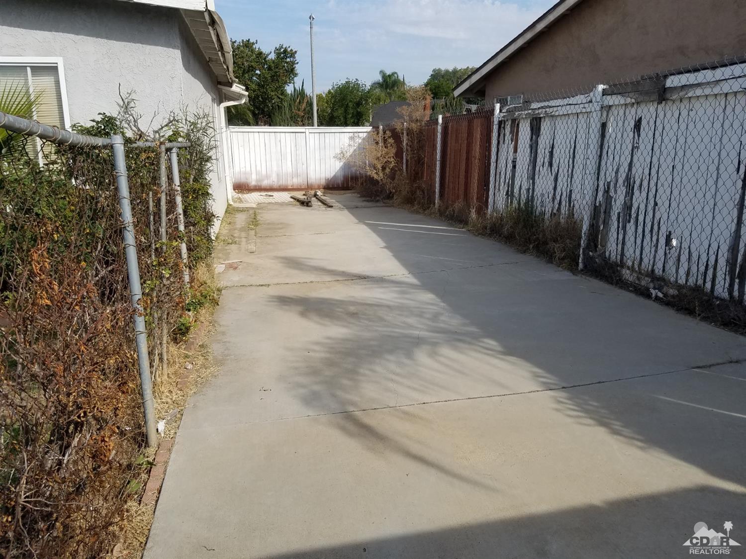 3166 Tomahawk Circle Riverside, CA 92503 - Photo 28 of 29 a view of a house with a wooden fence