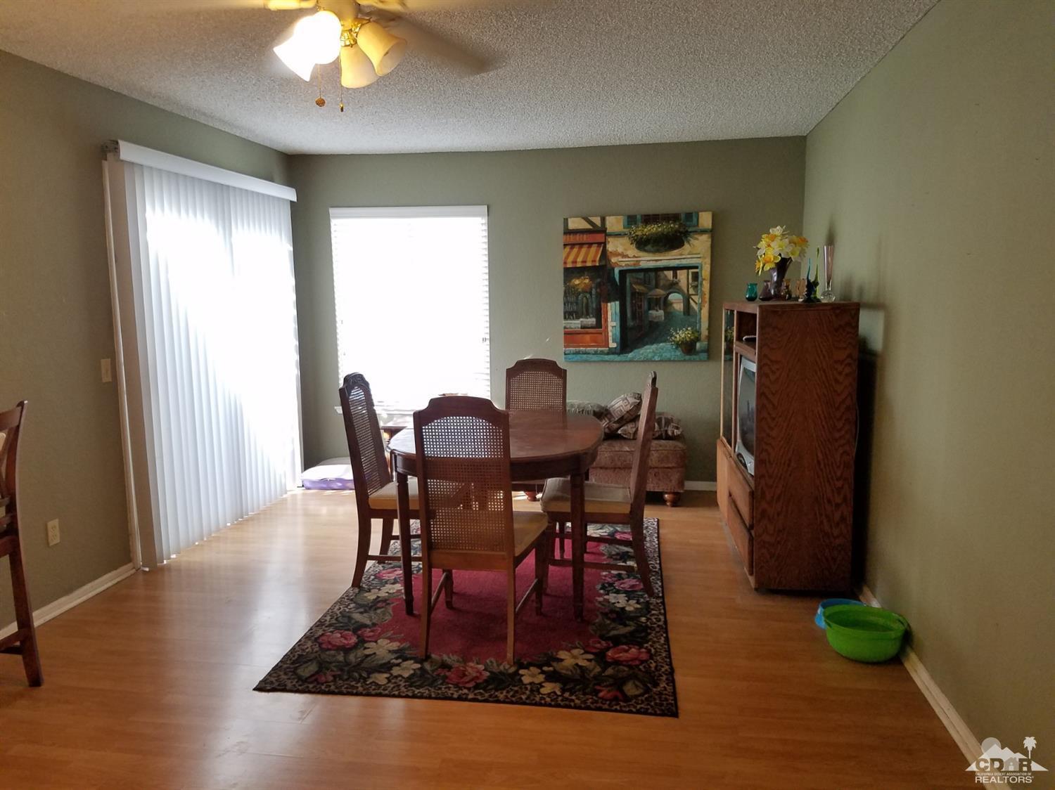 3166 Tomahawk Circle Riverside, CA 92503 - Photo 4 of 29 a view of a dining room with furniture and wooden floor