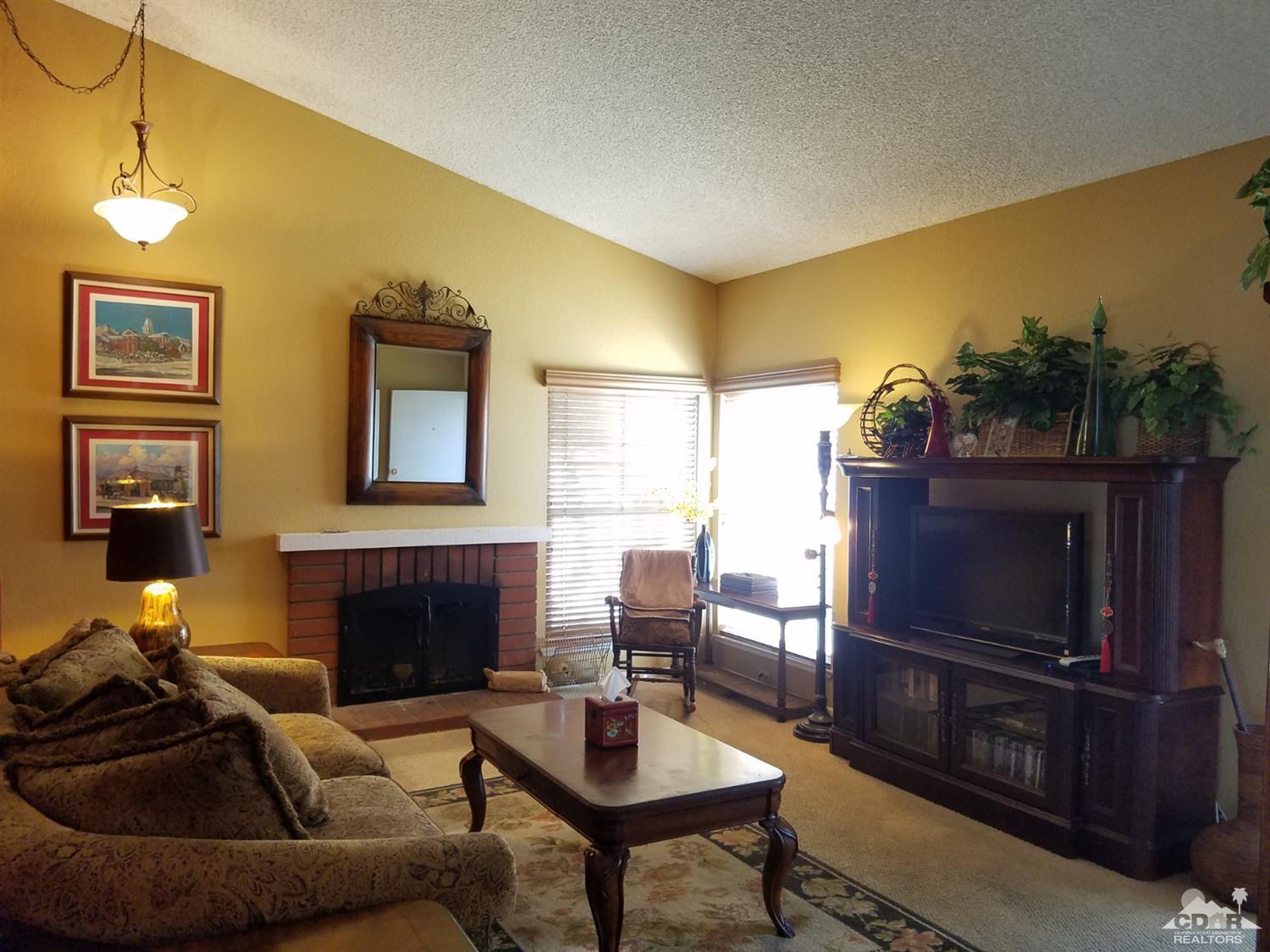 3166 Tomahawk Circle Riverside, CA 92503 - Photo 8 of 29 a living room with furniture a flat screen tv and a fireplace