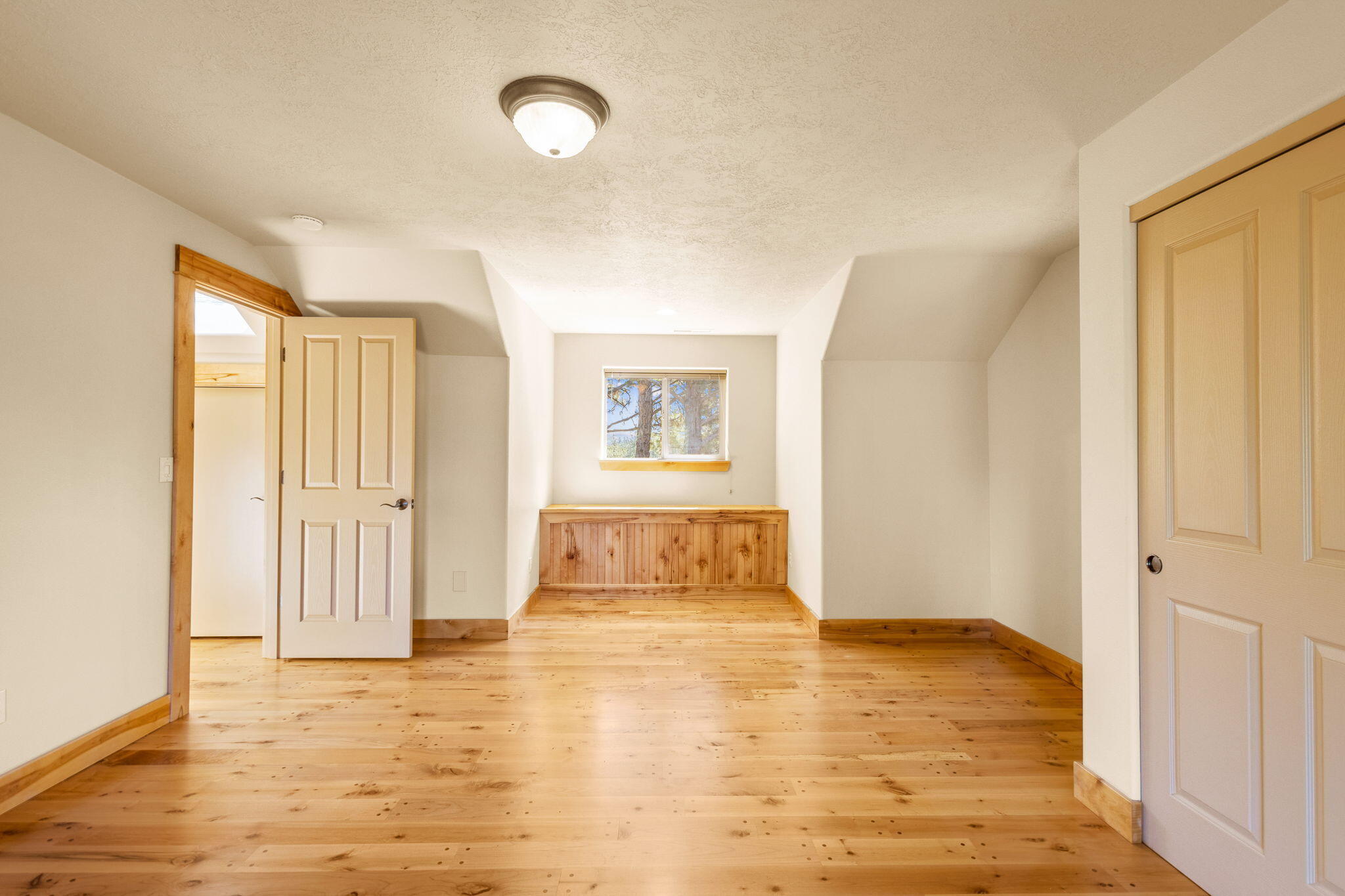 21405 Back Alley Road Bend, OR 97702 - Photo 29 of 48 a view of an empty room with wooden floor and a window