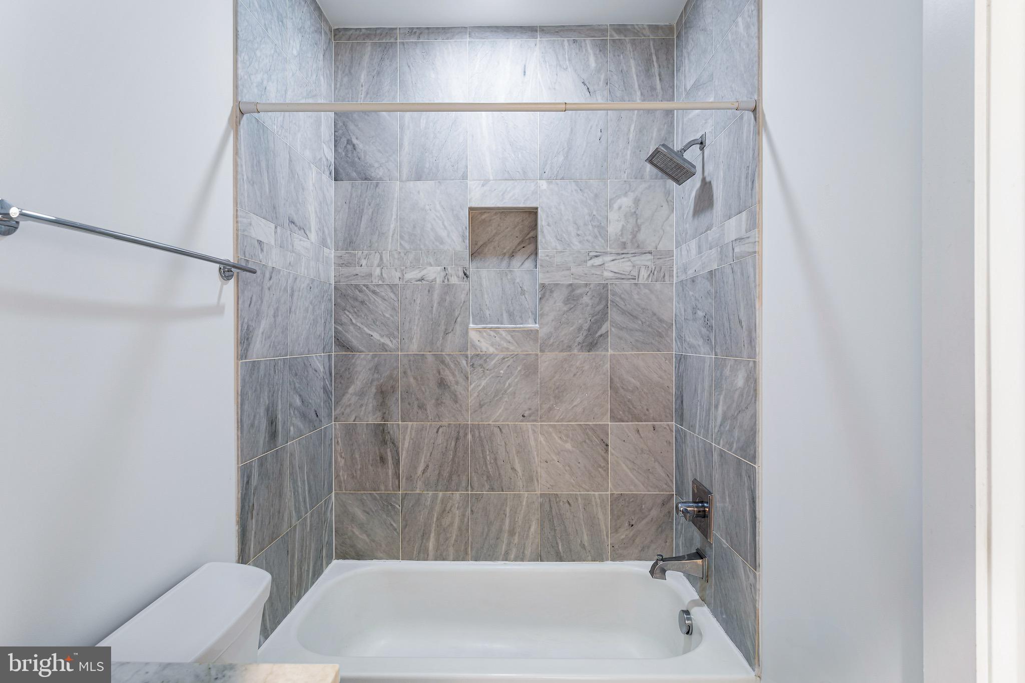 1221 Kenyon Street Northwest, Unit 2 Washington, DC 20010 - Photo 19 of 26 a bathroom with a shower and a toilet