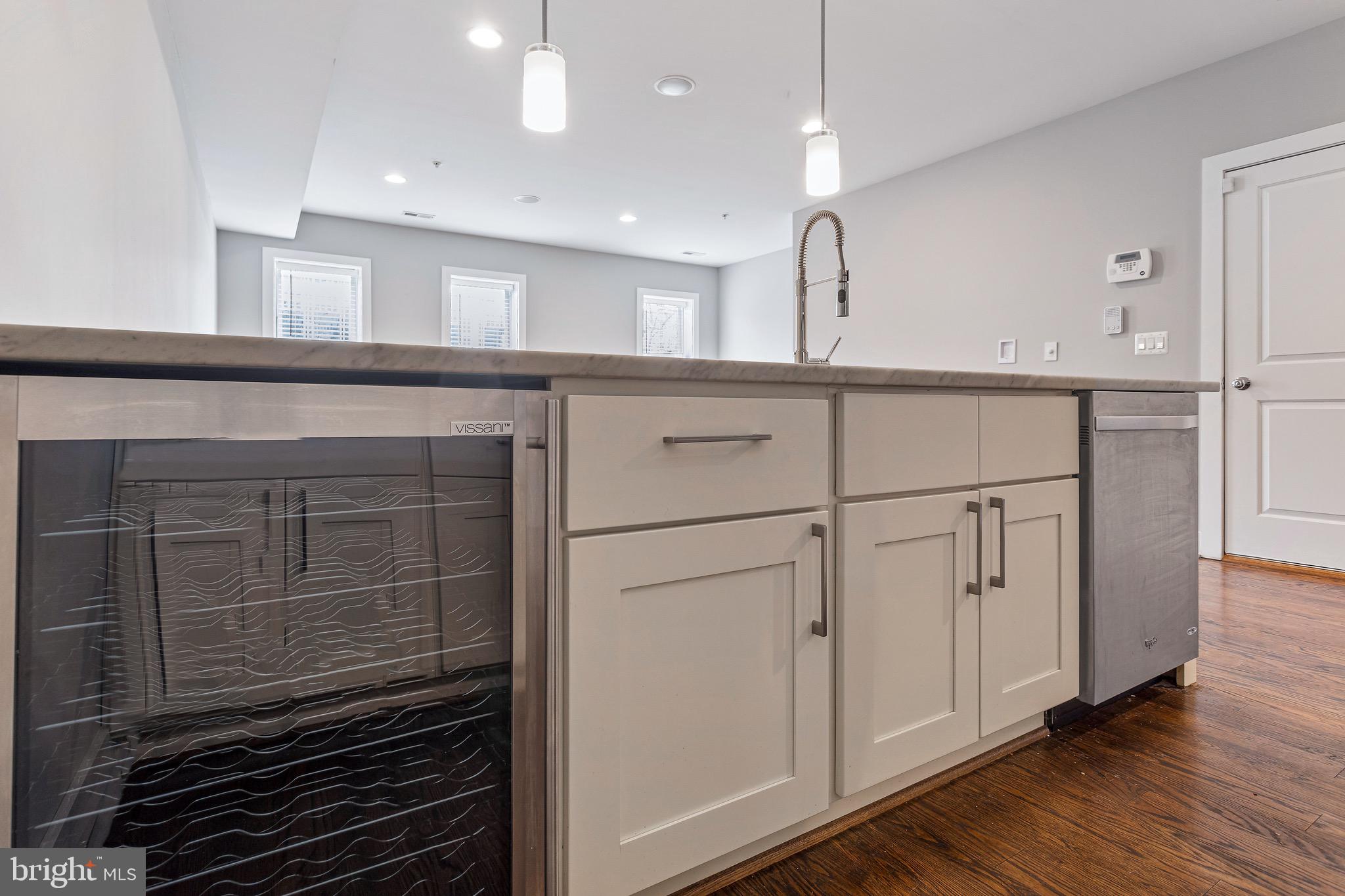 1221 Kenyon Street Northwest, Unit 2 Washington, DC 20010 - Photo 5 of 26 a kitchen with stainless steel appliances a refrigerator and cabinets