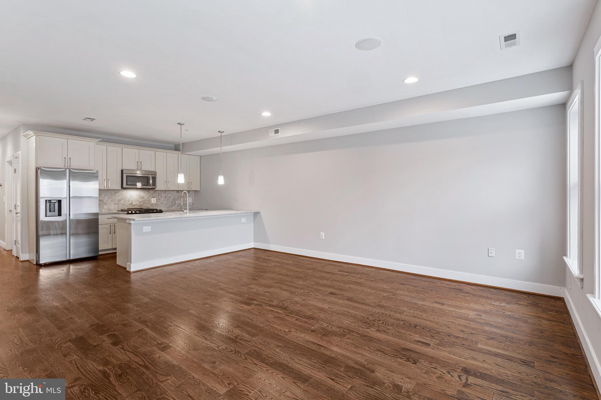 1221 Kenyon Street Northwest, Unit 2 Washington, DC 20010 - Photo 6 of 26 a view of kitchen with wooden floor