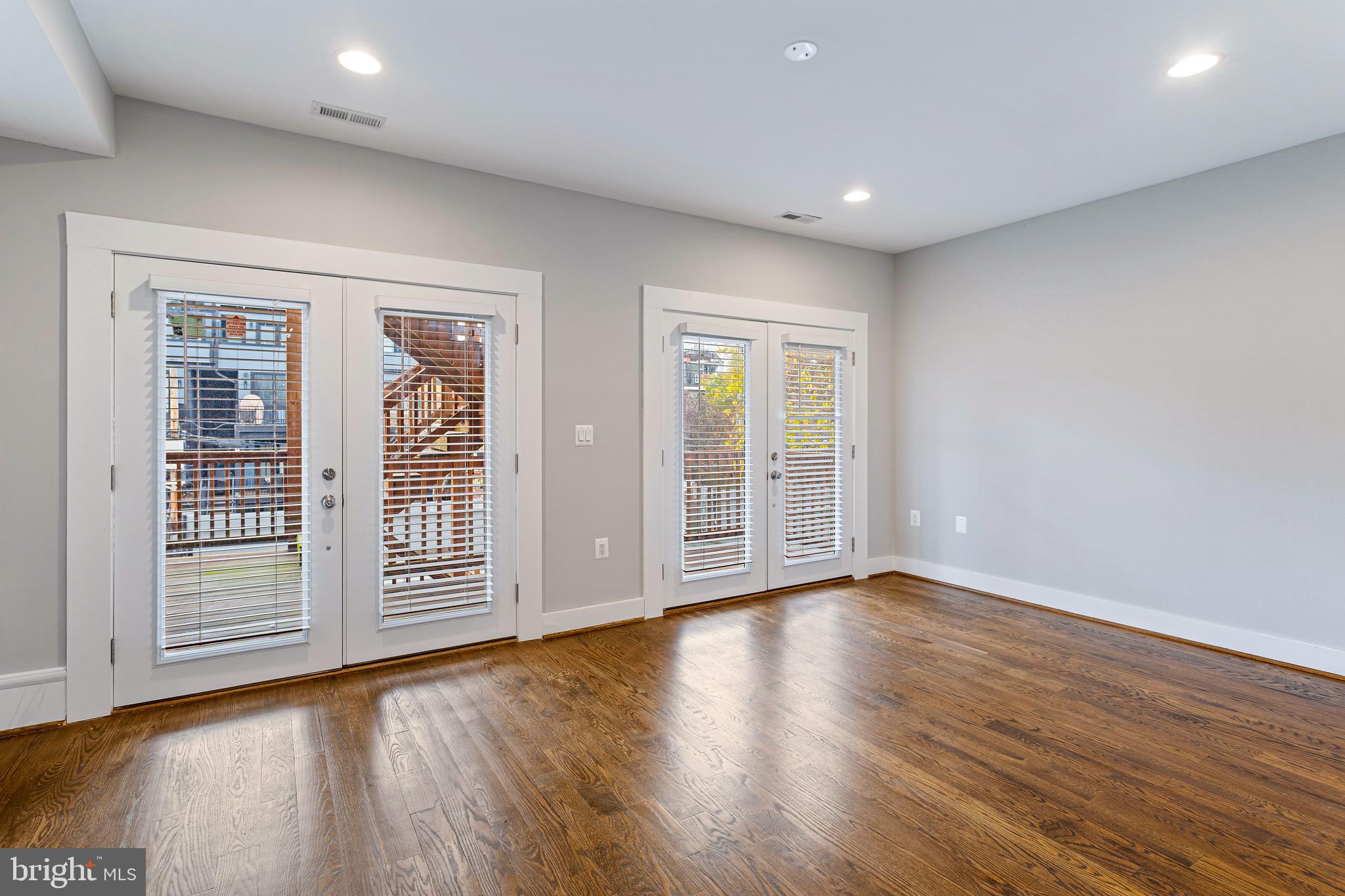 1221 Kenyon Street Northwest, Unit 2 Washington, DC 20010 - Photo 9 of 26 a view of empty room with wooden floor and fan