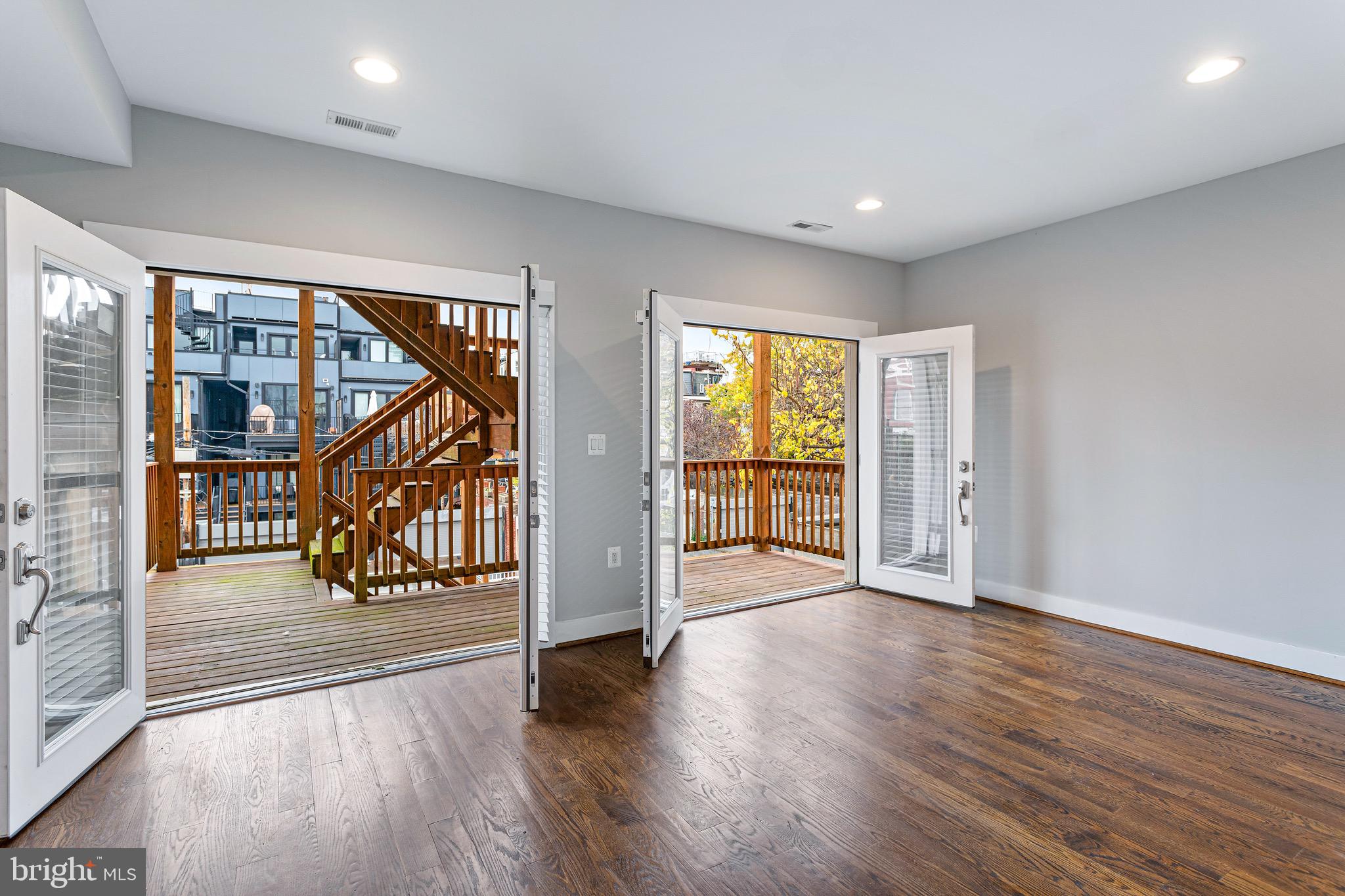 1221 Kenyon Street Northwest, Unit 2 Washington, DC 20010 - Photo 10 of 26 wooden floor in an empty room with a window