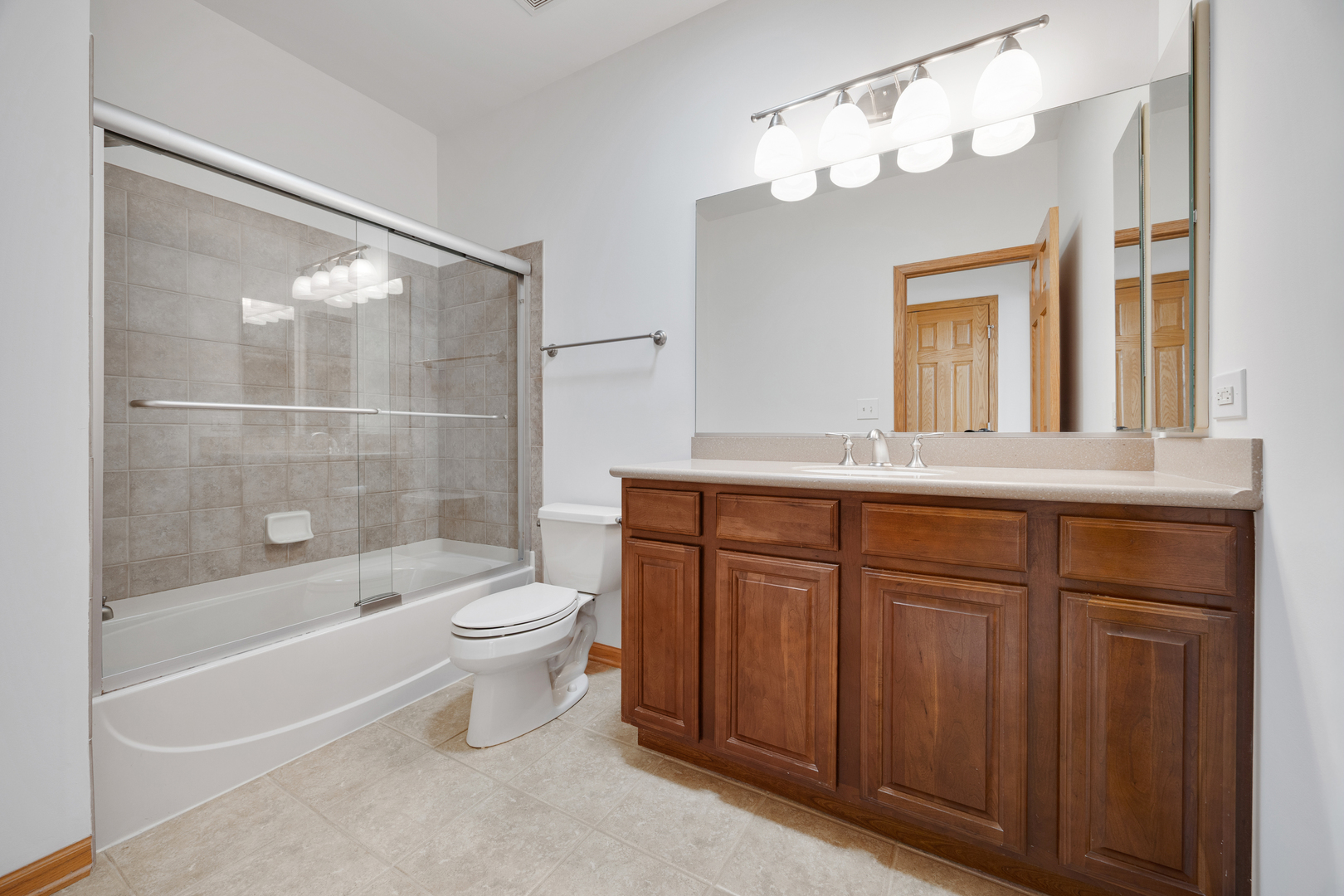 1385 Scarboro Road, Unit 204 Schaumburg, IL 60193 - Photo 16 of 18 a bathroom with a sink a toilet and shower
