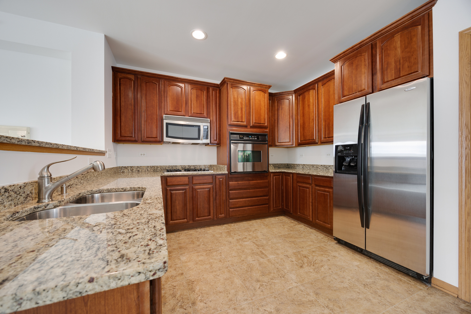 1385 Scarboro Road, Unit 204 Schaumburg, IL 60193 - Photo 2 of 18 a kitchen with stainless steel appliances granite countertop a refrigerator a stove top oven a sink and dishwasher
