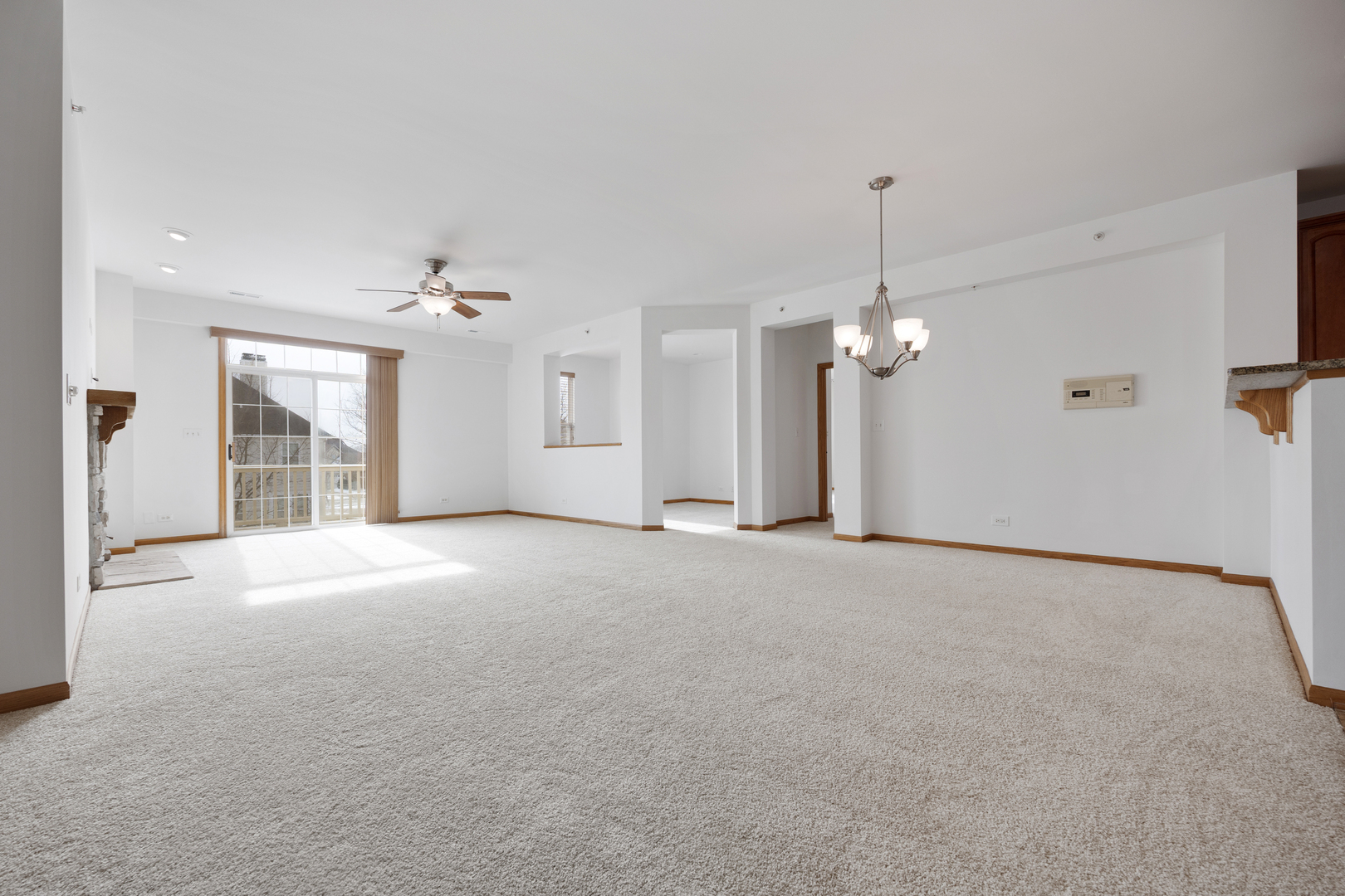 1385 Scarboro Road, Unit 204 Schaumburg, IL 60193 - Photo 5 of 18 a view of a big room with chandelier fan and windows