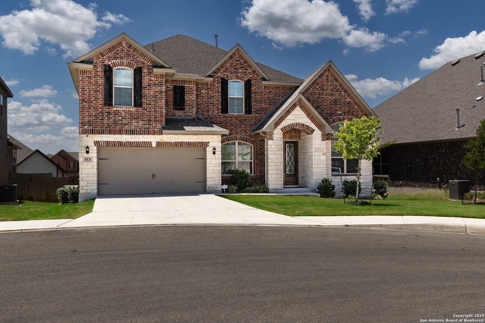 a front view of a house with a yard and garage