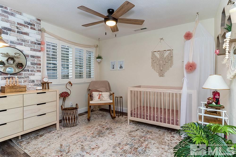 2075 Marsh Avenue Reno, NV 89509 - Photo 20 of 32 a bedroom with furniture and a large window