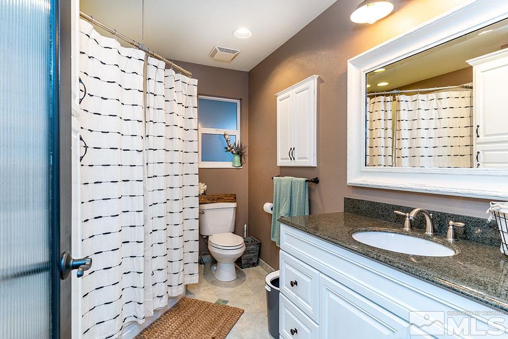 2075 Marsh Avenue Reno, NV 89509 - Photo 21 of 32 a bathroom with a sink toilet a mirror and shower