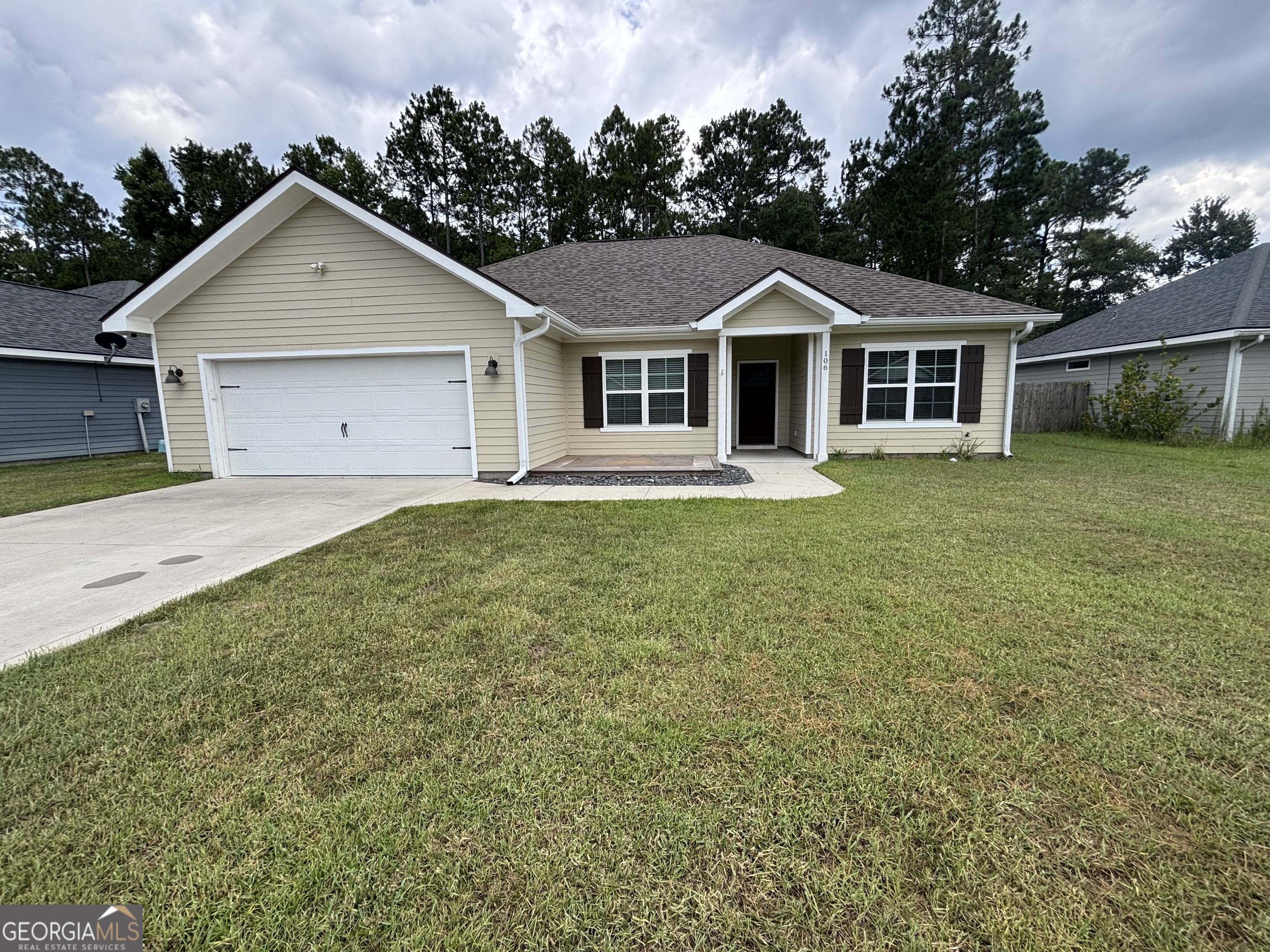a front view of a house with a yard and garage