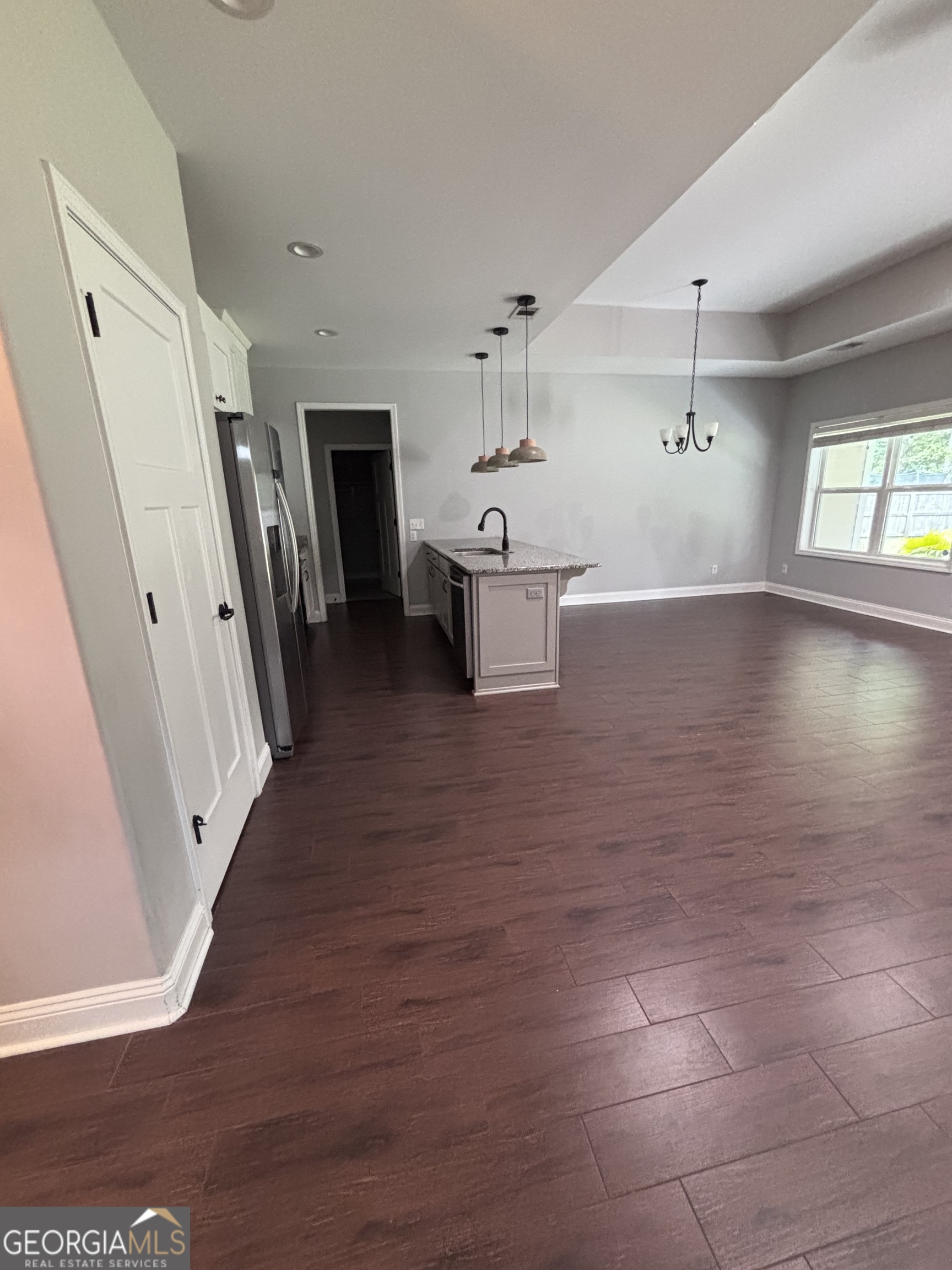 106 Logans Way Kingsland, GA 31548 - Photo 5 of 15 a view of a hallway with wooden floor and a living room