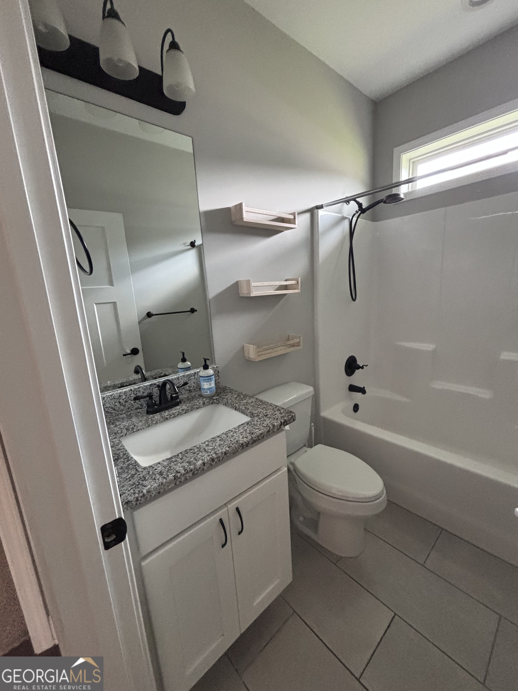 106 Logans Way Kingsland, GA 31548 - Photo 7 of 15 a bathroom with a granite countertop sink toilet and shower