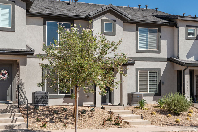 1693 Devils Gdn Lane Washington, UT 84780 - Photo 34 of 64 Contemporary townhome exterior featuring light gray stucco siding with dark gray trim accents