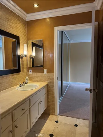 a spacious bathroom with a double vanity sink a mirror and a shower