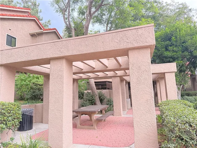a view of a patio with table and chairs and potted plants