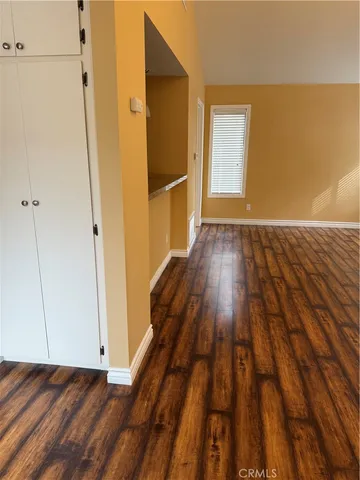 a view of a room with wooden floor and staircase