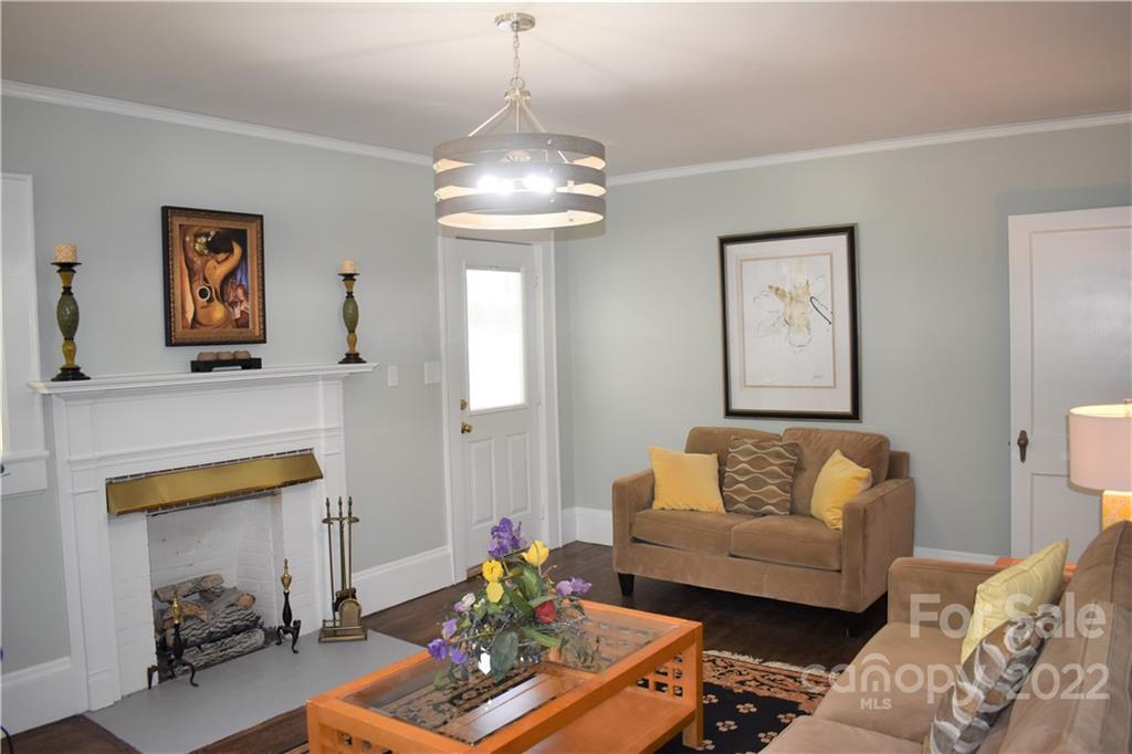 1301 Jackson Road Gastonia, NC 28052 - Photo 19 of 44 a living room with furniture and a chandelier