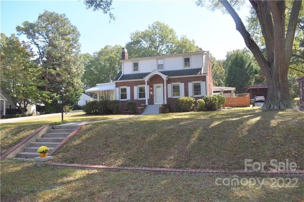 1301 Jackson Road Gastonia, NC 28052 - Photo 3 of 44 a front view of a house with a yard and large trees
