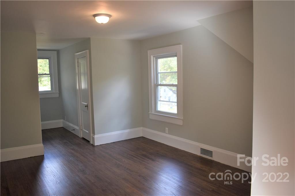1301 Jackson Road Gastonia, NC 28052 - Photo 32 of 44 an empty room with wooden floor and windows