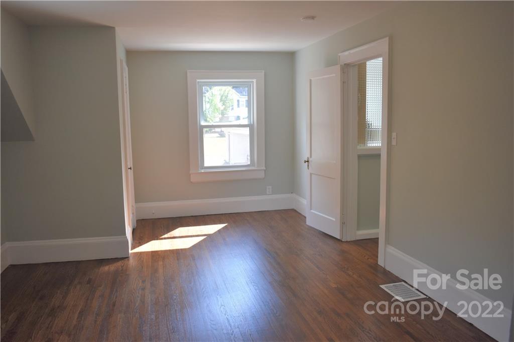 1301 Jackson Road Gastonia, NC 28052 - Photo 33 of 44 an empty room with wooden floor and windows