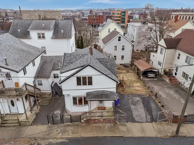 an aerial view of a house with a yard