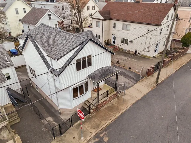 an aerial view of a house with a roof deck