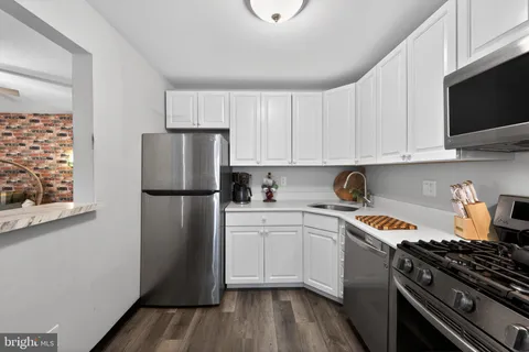 a kitchen with a refrigerator stove and sink