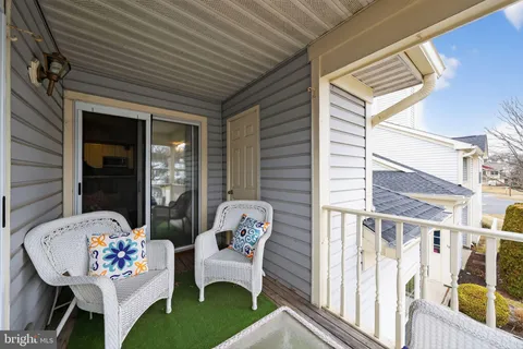 a front view of a house with outdoor seating