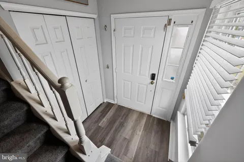 a view of a hallway with wooden floor and staircase