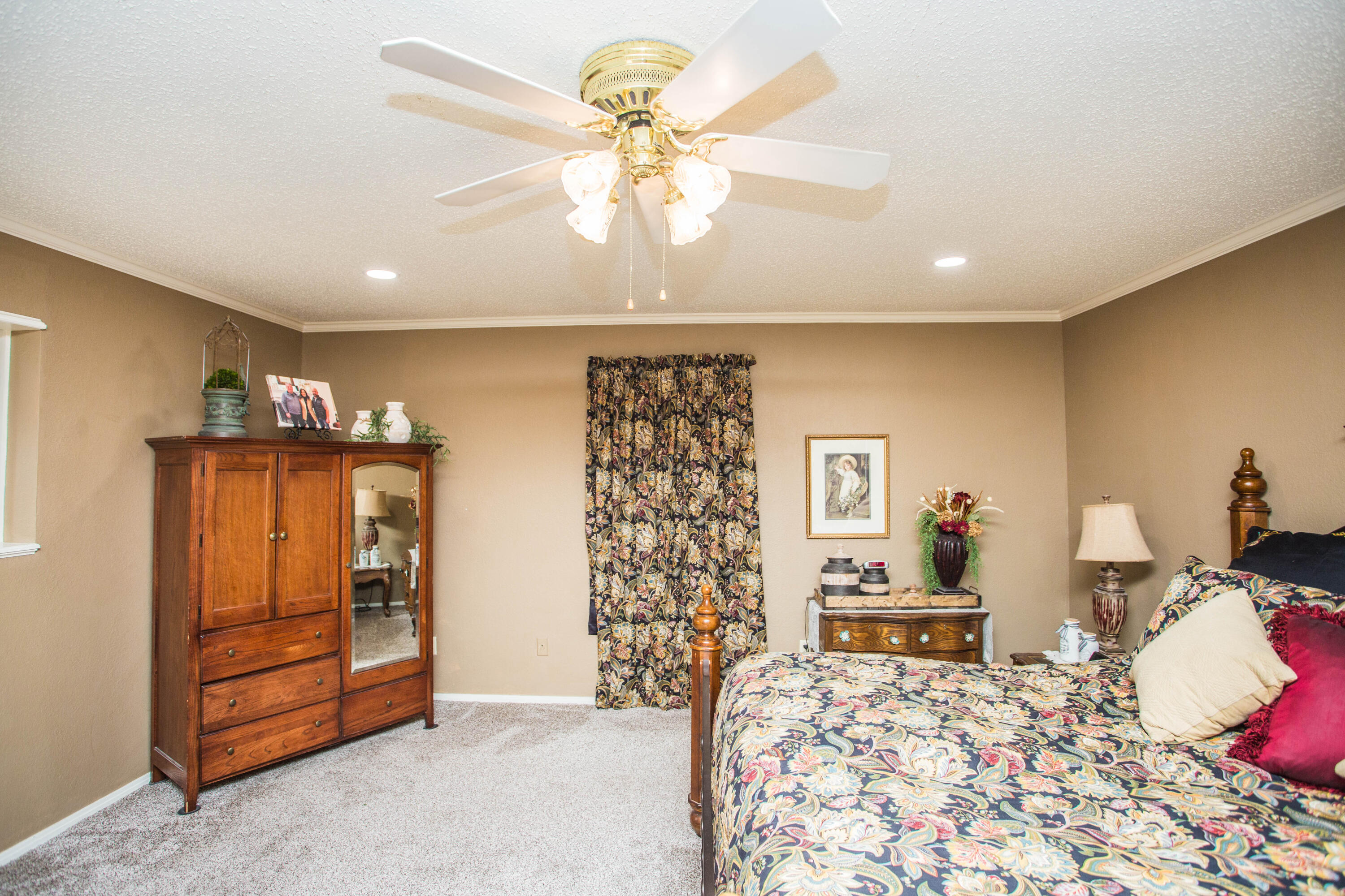 1304 Jefferson Drive Plainview, TX 79072 - Photo 18 of 50 a bedroom with furniture and a chandelier