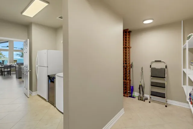 a kitchen with a sink and chairs