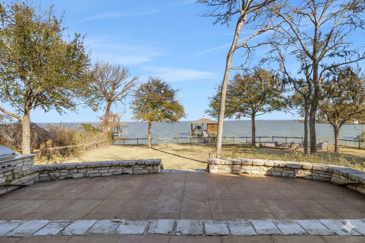 290 Harbor Run Drive Coldspring, TX 77331 - Photo 31 of 42 Relax on the covered back patio and take in views of the spacious yard and tranquil lake