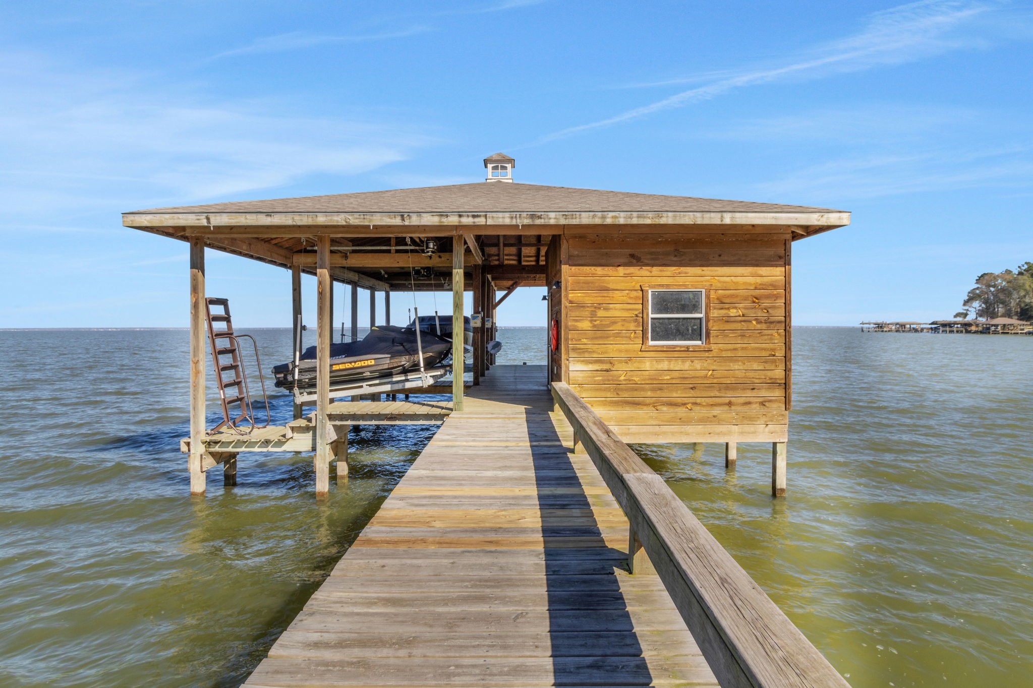 290 Harbor Run Drive Coldspring, TX 77331 - Photo 34 of 42 The boathouse has a great storage room, jet ski lift, boat lift, seating area and spider be gone system
