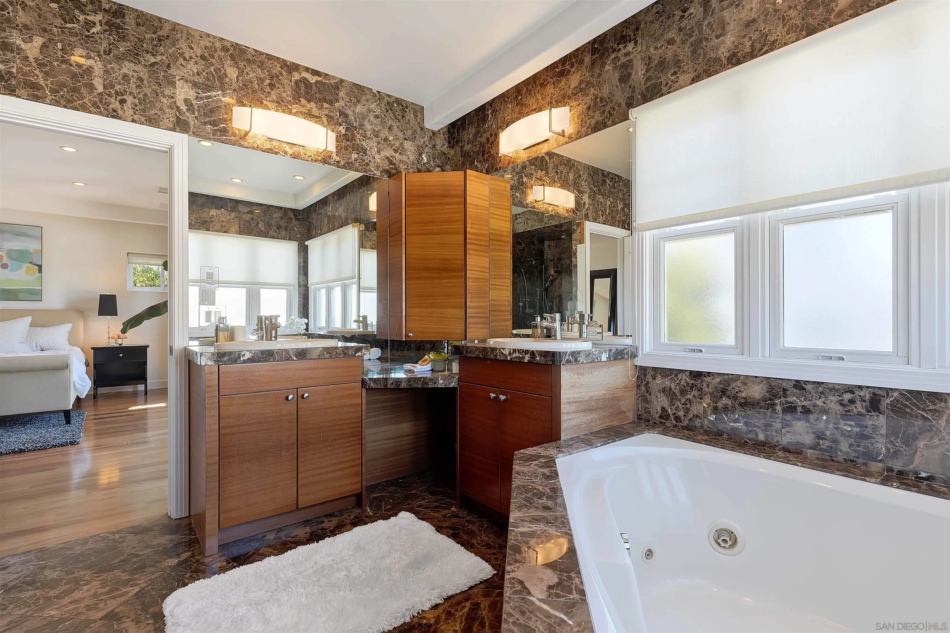 1022 G Coronado, CA 92118 - Photo 15 of 29 a bathroom with a tub a sink and mirrors