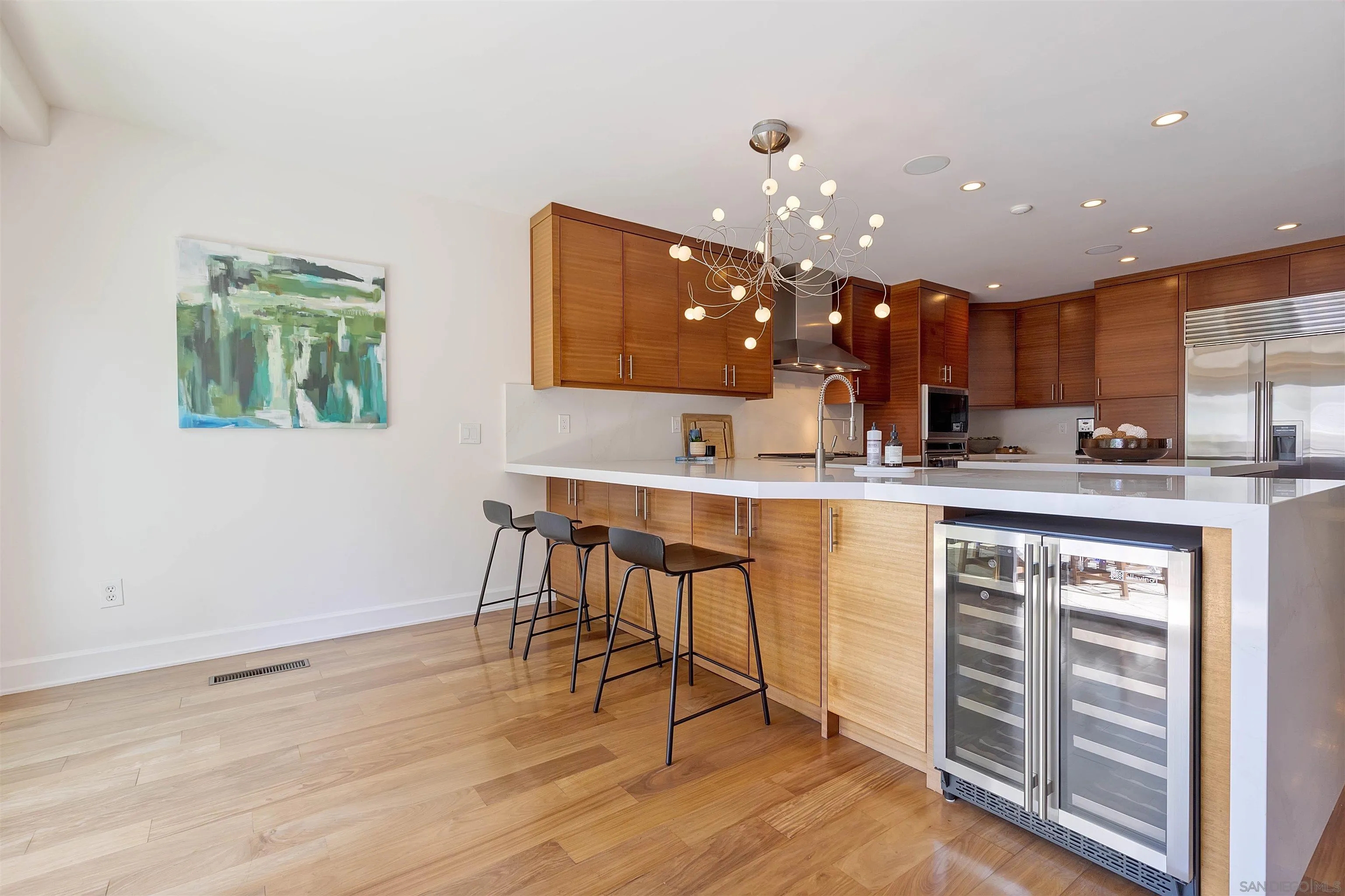 1022 G Coronado, CA 92118 - Photo 4 of 29 a kitchen with kitchen island granite countertop a sink cabinets and wooden floor