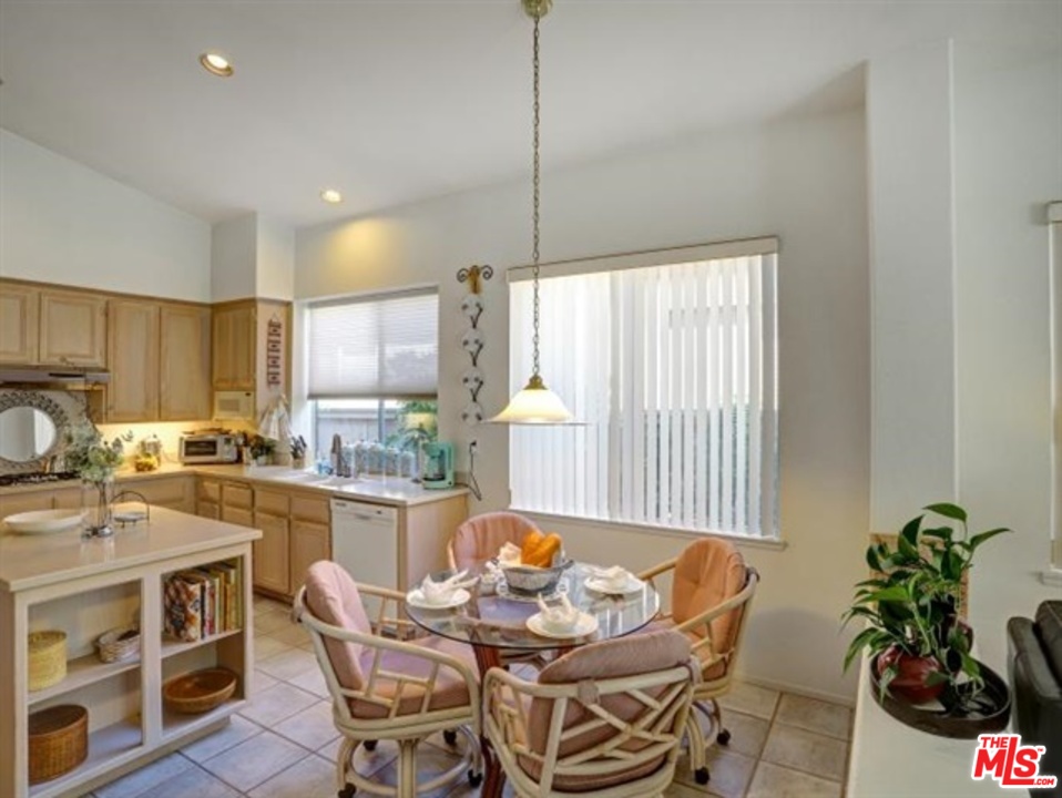11063 Mulgrave Road San Diego, CA 92131 - Photo 11 of 30 a dining room with furniture window and wooden floor