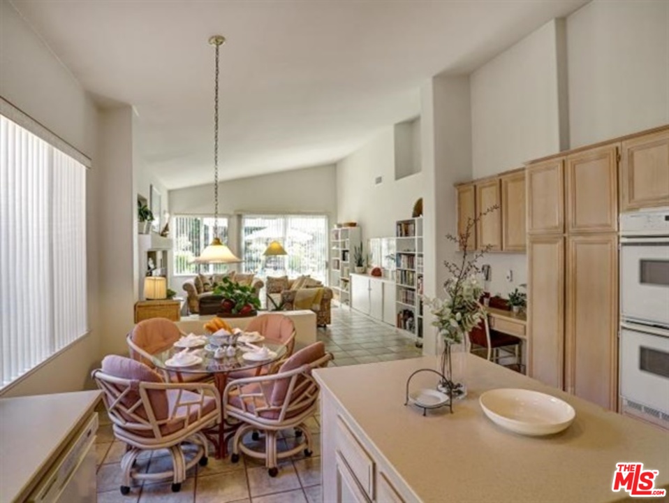 11063 Mulgrave Road San Diego, CA 92131 - Photo 12 of 30 a dining room with furniture a chandelier and wooden floor
