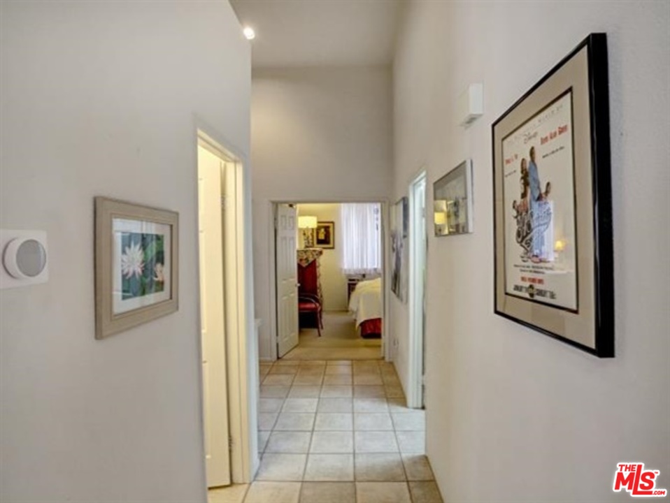 11063 Mulgrave Road San Diego, CA 92131 - Photo 17 of 30 a view of a hallway that has a painting on the wall
