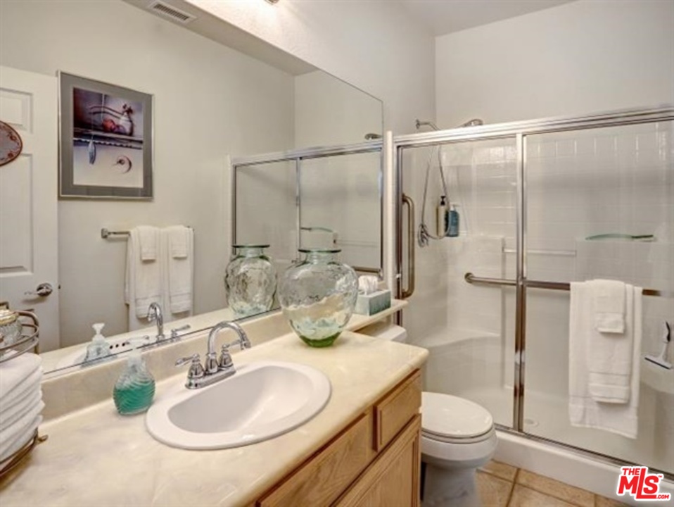 11063 Mulgrave Road San Diego, CA 92131 - Photo 18 of 30 a bathroom with a granite countertop sink toilet and shower
