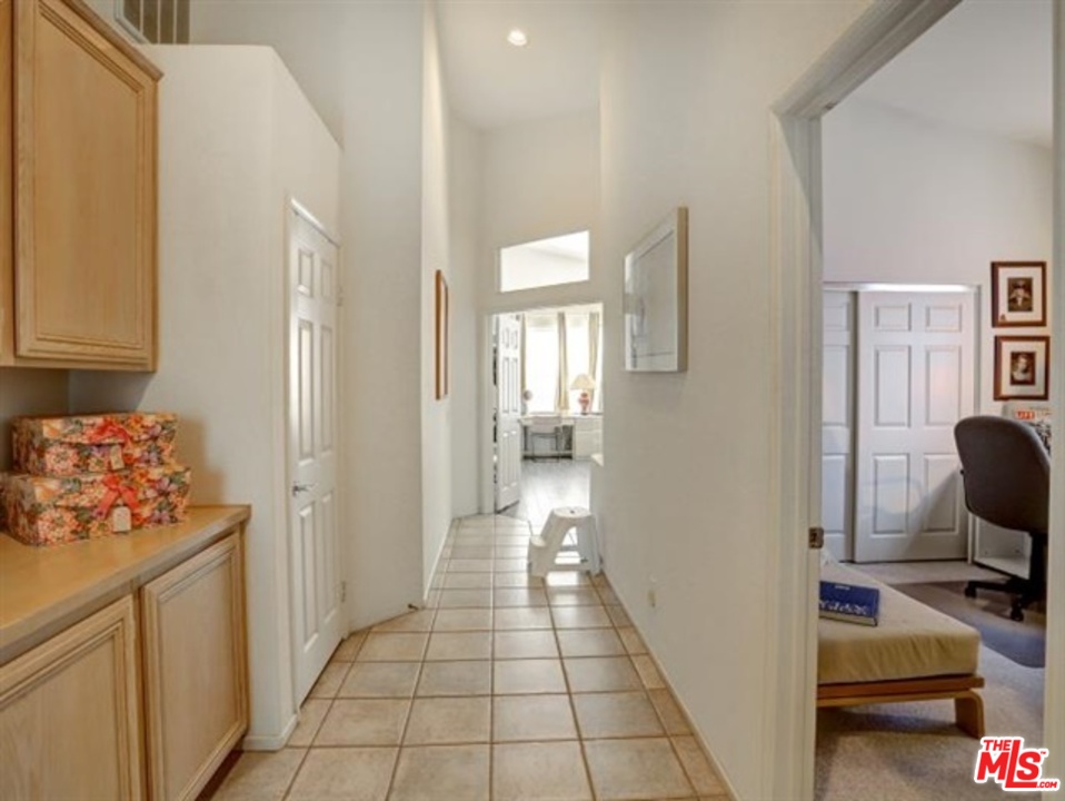 11063 Mulgrave Road San Diego, CA 92131 - Photo 24 of 30 a view of a hallway with workspace and a couch