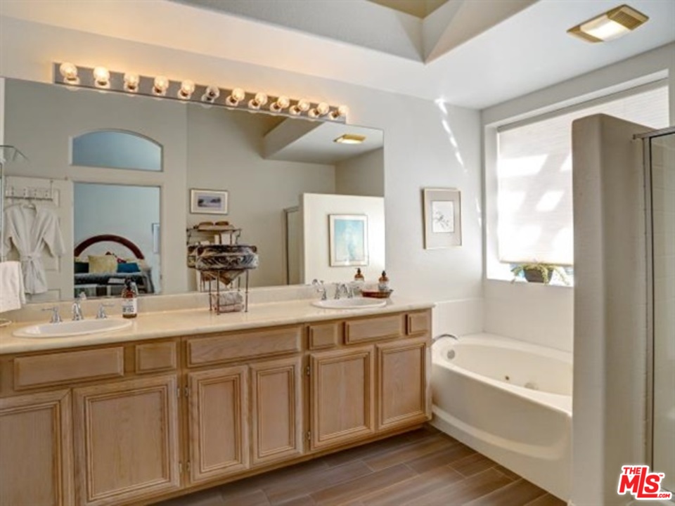 11063 Mulgrave Road San Diego, CA 92131 - Photo 27 of 30 a bathroom with a tub a double vanity sink and mirror
