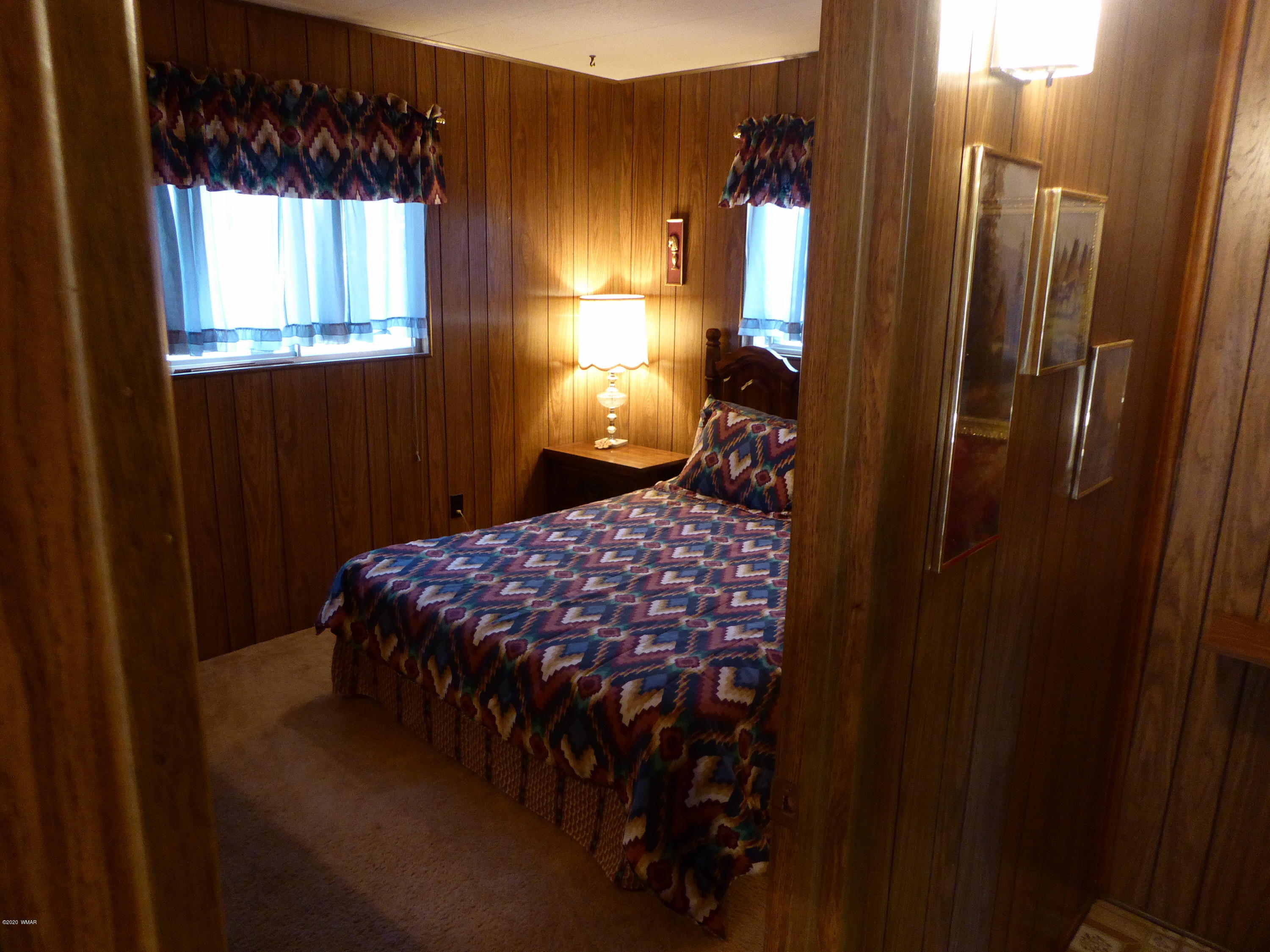 2898 Belle Road Overgaard, AZ 85933 - Photo 17 of 26 a bedroom with a bed and a window